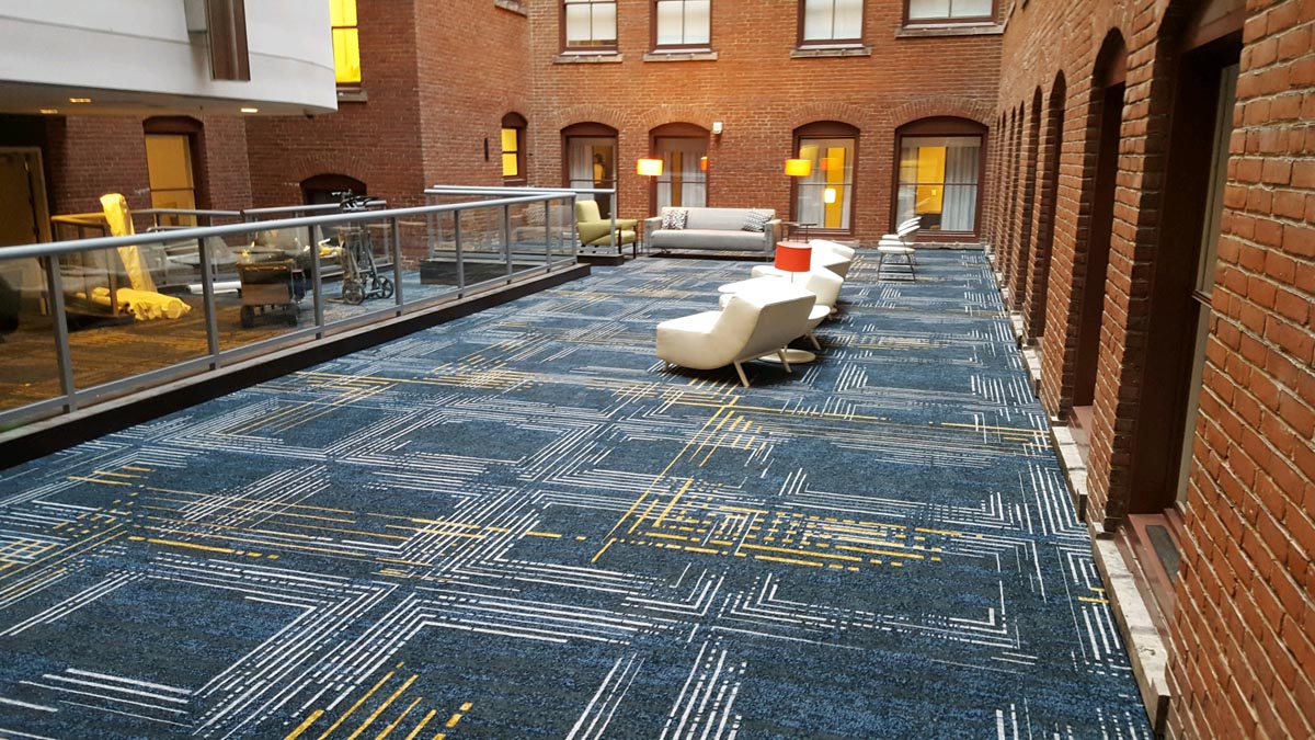 Carpet Versus Resilient Flooring 3 commercial broadloom or modular carpet with a geometric linear pattern